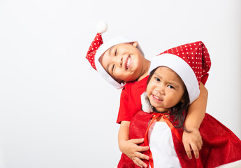 Asian little cute two brethren children boy and girl smile, Kids dressed in red Santa Claus hat...