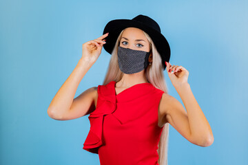 Fashion woman in trendy dress and cap. Sexy female posing in light blue background. Fashionable...