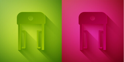 Paper cut Metal detector in airport icon isolated on green and pink background. Airport security guard on metal detector check point. Paper art style. Vector.