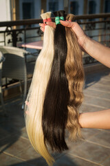strands of natural women's hair for encapsulation and extension in a beauty salon. 