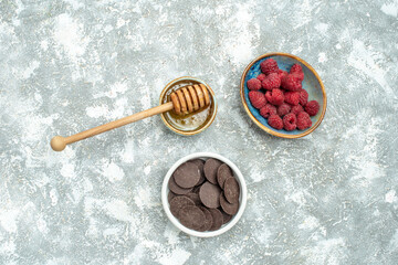 top view fresh raspberries with honey and choco biscuits on white background color fruit berry photo cookie