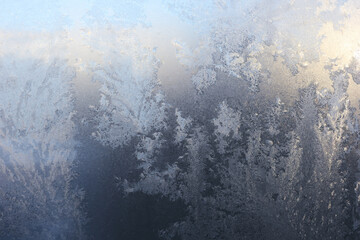 New year Christmas background. Frosty pattern, freeze on the window in winter. Horizontal orientation
