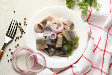 Concept of lunch with plate of fresh herring fish on white textured background