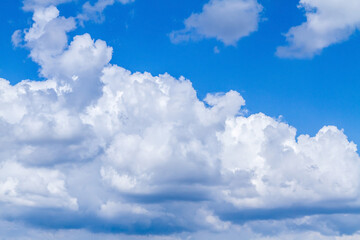 Naklejka na ściany i meble White clouds on a blue sky. Blue sky with heavy clouds. Clouds floating on the sky.