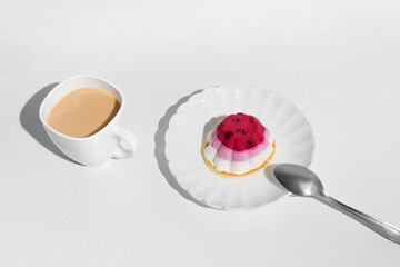 Cup of tea and cake with blueberries, white table background. Morning breakfast with dessert in the kitchen.
