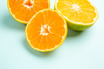 front view fresh tangerine slices on the light-blue background fruit orange photo color citrus grapefruit