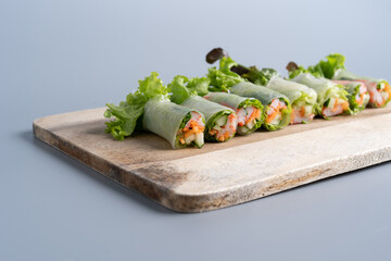 Salad Roll Crab Stick Salad, Cucumber, Carrot wood
Cutting board with gray background