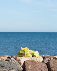 Fototapeta na wymiar yellow bags on the beach