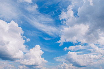 Naklejka na ściany i meble Picturesque white fluffy summer clouds on blue marvelous sky view background. Stock photo.