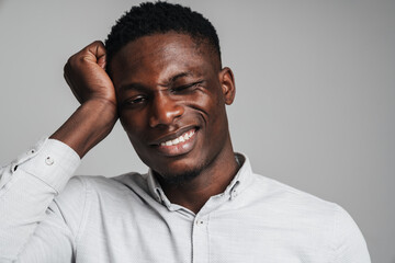 Fototapeta premium Upset african man in white shirt suffering