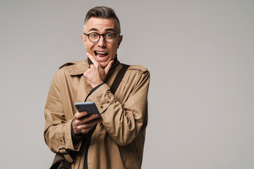 Handsome smiling man wearing stylish coat posing