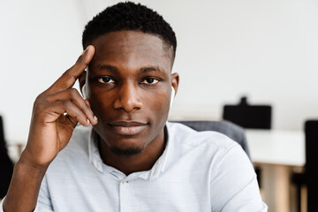 Afro american confident man in earphones looking at camera