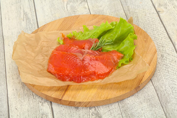 Sliced salmon fillet served rosemary