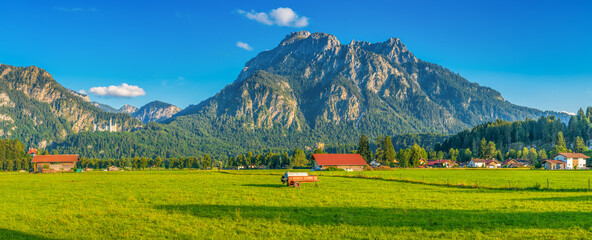 Panorama of Schwangau with Neuschwanstein Castle and Tegelberg mountain peak . Allg&auml;u region of Bavaria in Germany