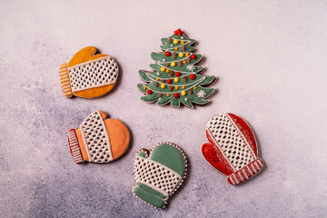 Christmas Gingerbread on gray concrete background. Close up. Snowflake, spruce, star, sleigh, cones, cone, star, bell shape.