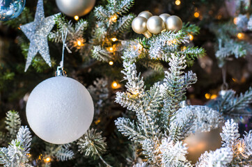 Obraz na płótnie Canvas Christmas balls of on a blurred background, decorated with a silver branch.