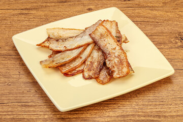 Roasted juicy bacon in the plate
