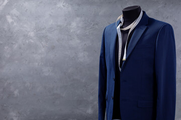suit jacket on male tailor mannequin and sewing tools - Powered by Adobe