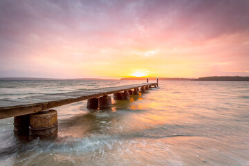 Sunset sky and long timber jetty