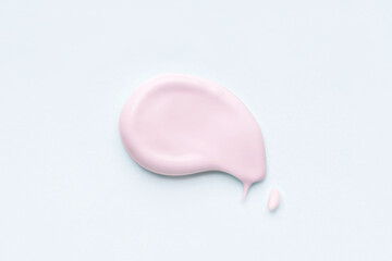 Pink smear of cosmetic cream or clay on a white background.