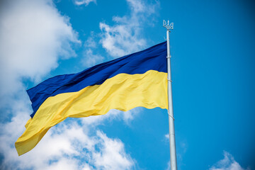 Ukrainian flag in the wind. Against the background of the sky