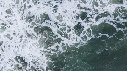 Beautiful scenic aerial landscape of splashing ocean waves with foam bubbles. High quality photo