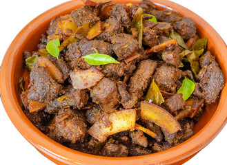 Kerala Special Beef Coconut Fry in a clay bowl in a traditional way - A Kerala Special Christmas Recipe - Isolated