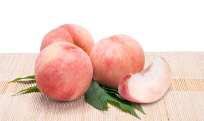 Sweet Peach fruit with leaf in Bamboo basket isolated on white background, Fresh Peach on White Background With clipping path.