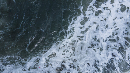 Beautiful scenic aerial landscape of splashing ocean waves with foam bubbles. High quality photo