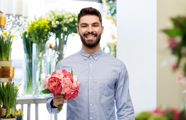 international women's day and greeting concept - happy smiling man with bunch of peonies over flower shop background