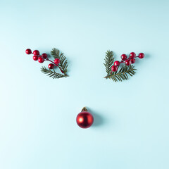 Reindeer face made with Christmas bauble decoration, holly berries, antlers and pine branches....