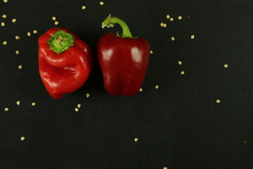Red peppers on black background