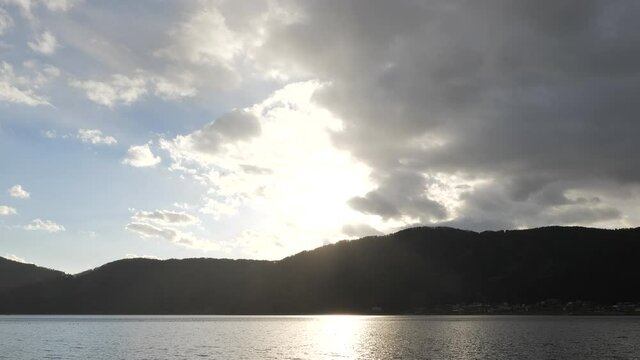 Lake Yogo in Shiga Prefecture at dusk, illuminated by strong backlighting.