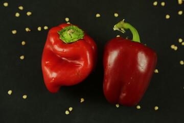 Red peppers on black background