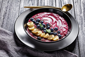 Blueberry and banana smoothie on a black plate