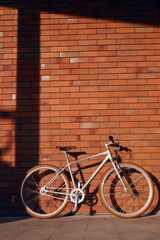 Fototapeta na wymiar Bicycle parked near brick wall
