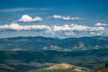 Beautiful summer panoramic landscape in mountain highlands with white clouds near Pylypets, Ukraine 