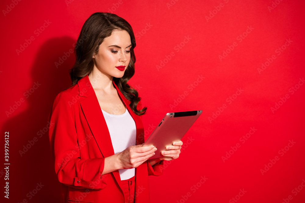 Poster Photo of gorgeous young girl hold tablet look screen calm face wear jacket isolated red color background