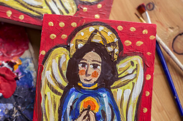 The angel is drawn on a board in ancient style of painting.