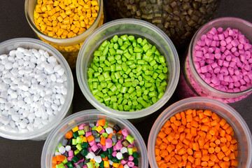 Plastic granules in a measuring container and test tubes in the laboratory. Plastic pellets. Dyes for plastic, polypropylene, polyethylene