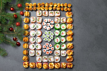 Sushi on christmas background. Christmas tree with toys and sushi rolls set for menu and advertising. Christmas pattern with food