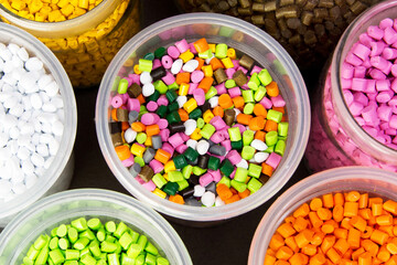 Plastic pellets. Dyes for plastic, polypropylene, polyethylene. Plastic granules in a measuring container and test tubes in the laboratory.