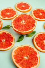 front view tasty fresh grapefruits lined on a light-blue background health fruit diet fresh juice color