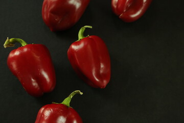 Red peppers on black background
