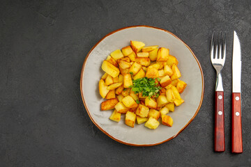 top view tasty fried potatoes inside plate with greens on dark background photo food oil french fries dinner