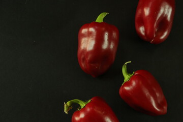 Red peppers on black background