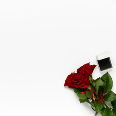 Bouquet of roses with box for ring on white background. Saint Valentine template, flat lay, top view