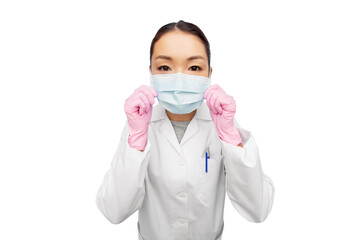 health, medicine and pandemic concept - young asian female doctor or scientist wearing face protective medical mask and gloves for protection from virus disease