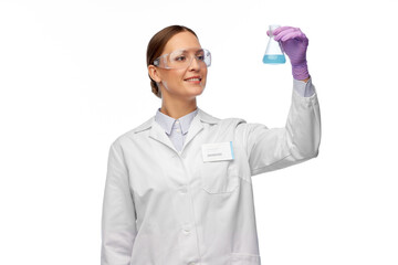 science, chemistry and people concept - happy smiling young female scientist in goggles with...