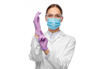 science, health and medicine concept - young female doctor or scientist wearing gloves, goggles and face protective medical mask for protection from virus